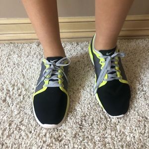Gray, yellow, and black nike training shoes